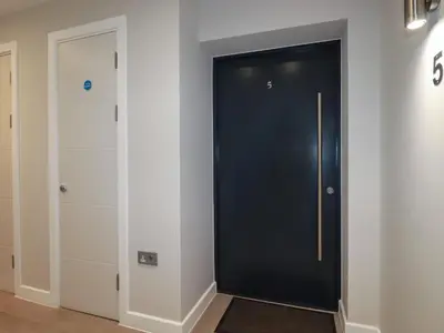 a black door in a room with a closet at Fistral Tide in Newquay