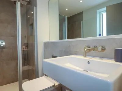 a bathroom with a sink and a shower and a toilet at Fistral Tide in Newquay