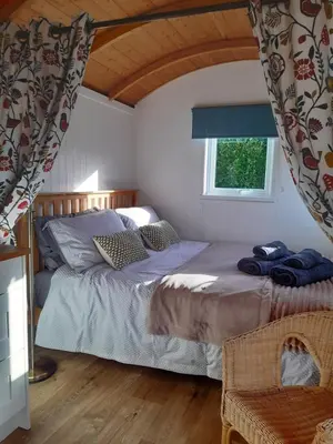 a bedroom with two beds and a window at The Shepherd Hut in Carleen