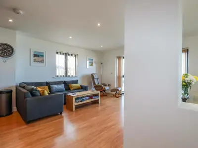a living room with a couch and a table at Apartment 3 in Newquay