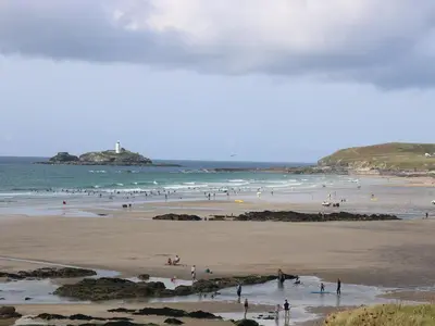a group of people on a beach near the ocean at Chalet 3 Wipeout in Hayle