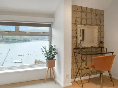 a room with a window with a view of the water at Crew Quarters in Fowey