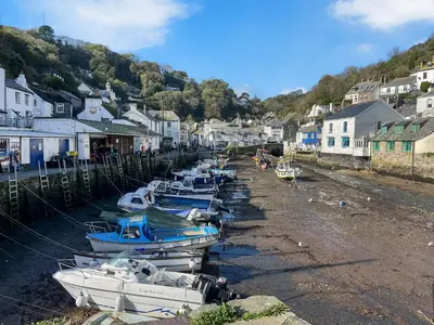 a group of boats are docked in a harbor at Harbour Studio in Polperro