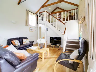 a living room with a couch and a table at Turtle Cottage in Charlestown