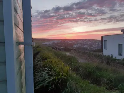 a view of a sunset from a house at PerranporthCaravan 2bedroom Tv GasFire in Perranporth