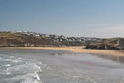 a sandy beach with buildings in the background at Modern Apartment Sea Views Private Parking in Newquay
