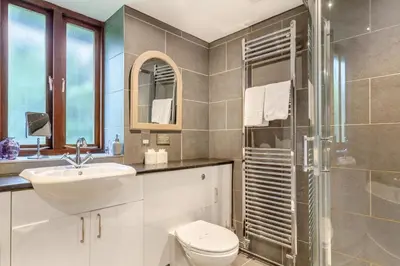 a bathroom with a toilet and a sink and a shower at 4 Bed in Torpoint oc-m30122 in Downderry