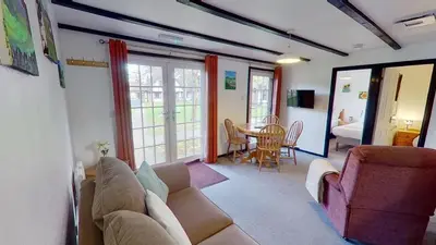 a living room with a couch and a table at 14 Tudor Court, Tolroy Manor in Hayle