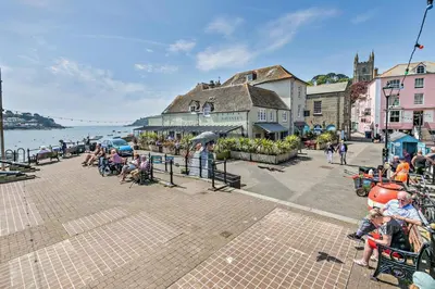 a group of people sitting in chairs near the water at 2 Bed in Fowey oc-r30265 in Fowey