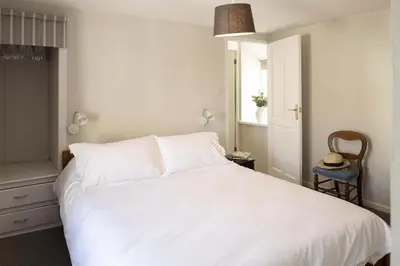 a bedroom with a white bed and a window at Gorgeous Cottage Parking Short Walk to Beach in Gorran Haven