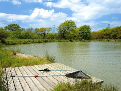 a boat is tied to a dock on a river at Miller's Cottage -Uk48595 in Warbstow