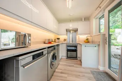 a kitchen with a washer and dryer at 1 Bed in Tresillian oc-p30116 in Saint Clement