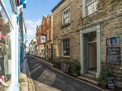 an empty street in an alley with buildings at Byre Cottage in Fowey