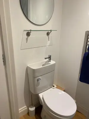a bathroom with a white toilet and a mirror at Seaside Cabin Perranporth in Perranporth