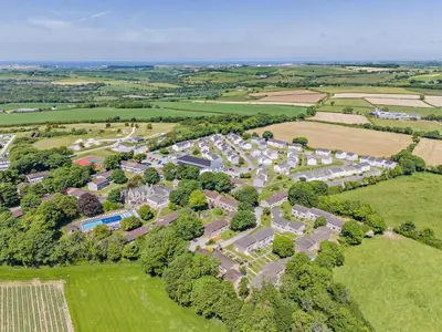 an aerial view of a village in a field at 4 Bed in Newquay oc-c30589 in Saint Columb Major