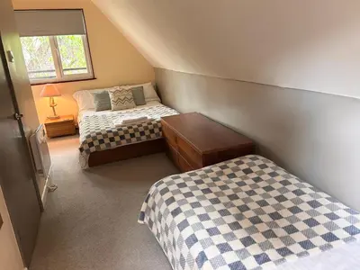 a small bedroom with two beds and a window at Trevithick 46 in Hayle