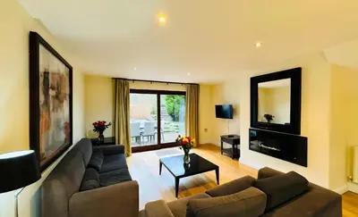 a living room with a couch and a table at Hustyn Lodges in Saint Wenn