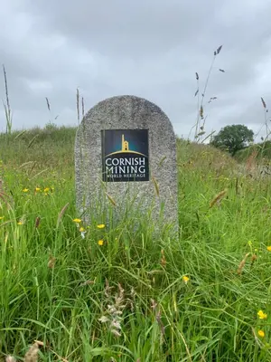 a stone sign sitting in a field of grass at Field View in Liskeard