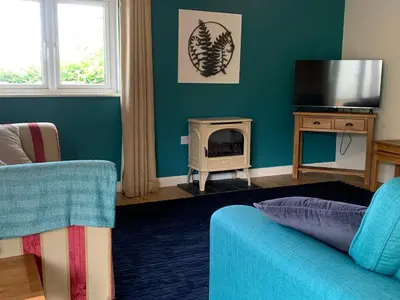 a living room with a couch and a fire place at Field View in Liskeard