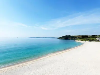 a view of a beach with the blue water at The Little Pines - 5 min walk to beach and sauna in Falmouth
