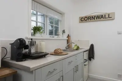 a kitchen with a counter with a coffee maker and a sink at Olive Cottage, Carbis Bay - Parking Nearby, Free WiFi, Coffee Machine - Couples Retreat in Carbis Bay