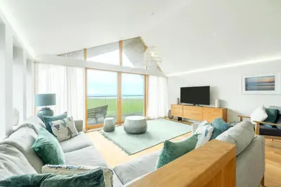 a living room with a couch and a tv at 3 Bed in St. Eval oc-k30666 in Saint Eval
