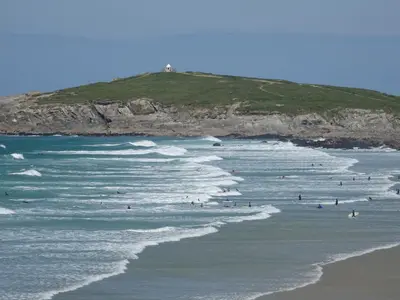 a group of people in the water at the beach at Beachside Fistral, Newquay in Newquay