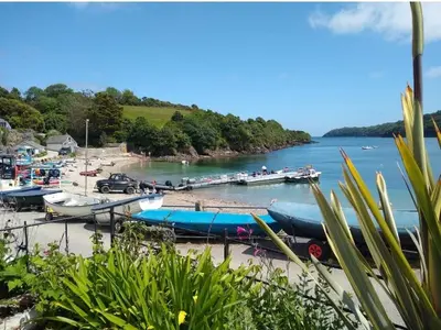 a bunch of boats are docked on a beach at Seaview Stable Barn in Penryn