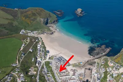 a map of a beach with a red arrow at Sandy Nook, Portreath, Cornwall in Portreath