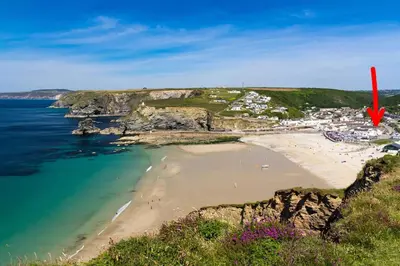 an aerial view of a beach with a red arrow at Sandy Nook, Portreath, Cornwall in Portreath