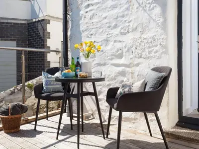 a table and two chairs on a patio at The Loft in Porthleven