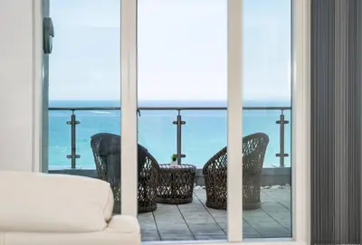 a view of the ocean from the balcony of a house at 25 Rocklands in Newquay in Newquay