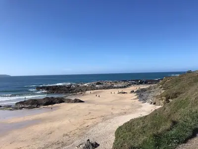 a group of people on a beach near the ocean at Lovely Shepherds hut near St Ives Cornwall in Gwinear Road Station