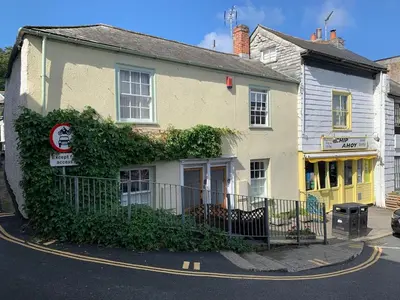 a yellow building with a sign in front of it at Maypole Cottages - No 12 Broad Street in Padstow