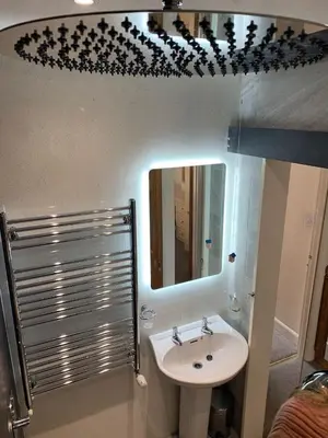 a bathroom with a sink and a mirror at Maypole Cottages - No 12 Broad Street in Padstow