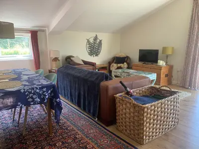 a living room with a couch and a table at Stable End in Liskeard