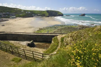 a staircase leading to a beach with the ocean at Hot Tub Bungalow - Close to Portreath - Free WiFi - Free Parking - Pet Friendly in Redruth