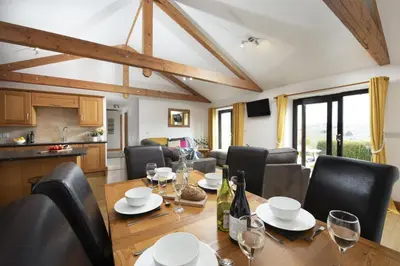 a dining room with a table and chairs at Hot Tub Bungalow - Close to Portreath - Free WiFi - Free Parking - Pet Friendly in Redruth