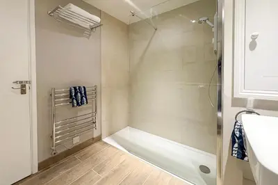a bathroom with a shower with a glass door at 2 Bed in Little Petherick oc-o30788 in Little Petherick