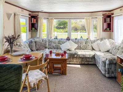 a living room with a couch and a table at Demelzas Retreat in Redruth
