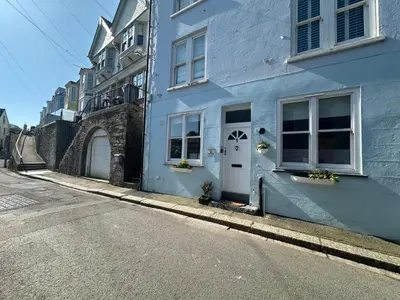 a blue building on the side of a street at The Slipway Suite Fowey Harbour & Parking 1 Min in Fowey
