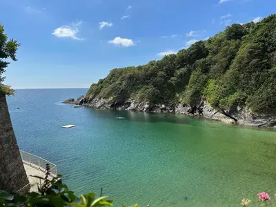 a large body of water next to a mountain at The Slipway Suite Fowey Harbour & Parking 1 Min in Fowey