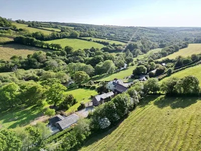 an aerial view of a house in a field at Riverside barn on private wildlife estate in Washaway