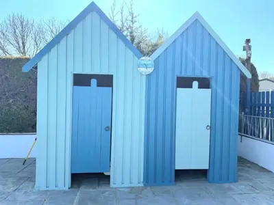 a blue shed with two doors on a patio at Cornwall Caravan Retreat 3 Crantock in Crantock