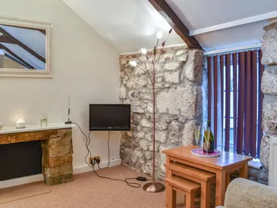 a living room with a tv and a fireplace at The Piggery - Uk49014 in Liskeard
