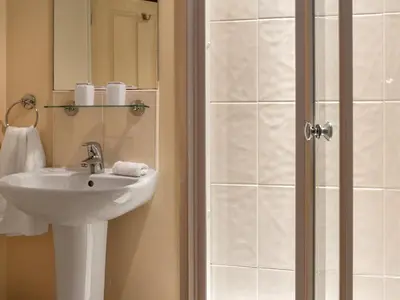 a bathroom with a sink and a shower at The Piggery - Uk49014 in Liskeard