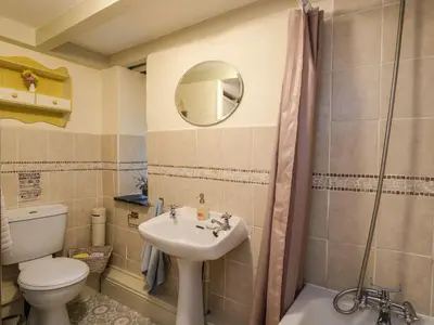 a bathroom with a sink and a toilet and a mirror at The Mill in Lostwithiel