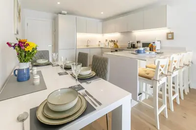 a kitchen with a table with plates and glasses on it at 2 Bed in Fowey oc-o31260 in Fowey