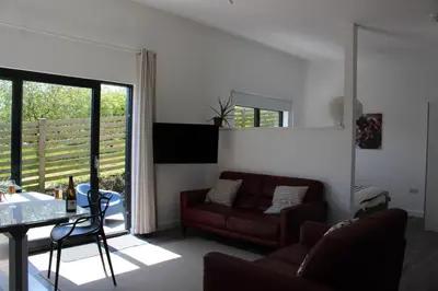 a living room with a couch and a table at Cicero's Lodge in Padstow