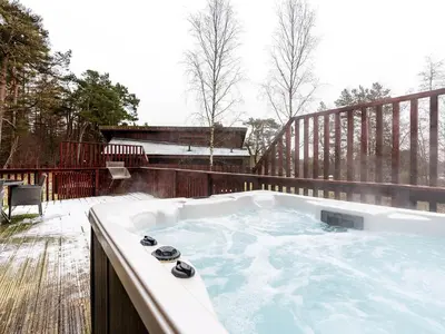 a jacuzzi tub sitting on a deck at Deerpark Cabins, Cornwall - Forest Holidays in Liskeard